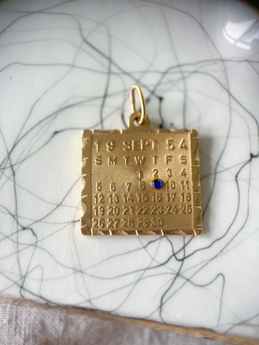 Vintage Calendar with Natural Sapphire 14k Yellow Gold Charm, circa 1950s
