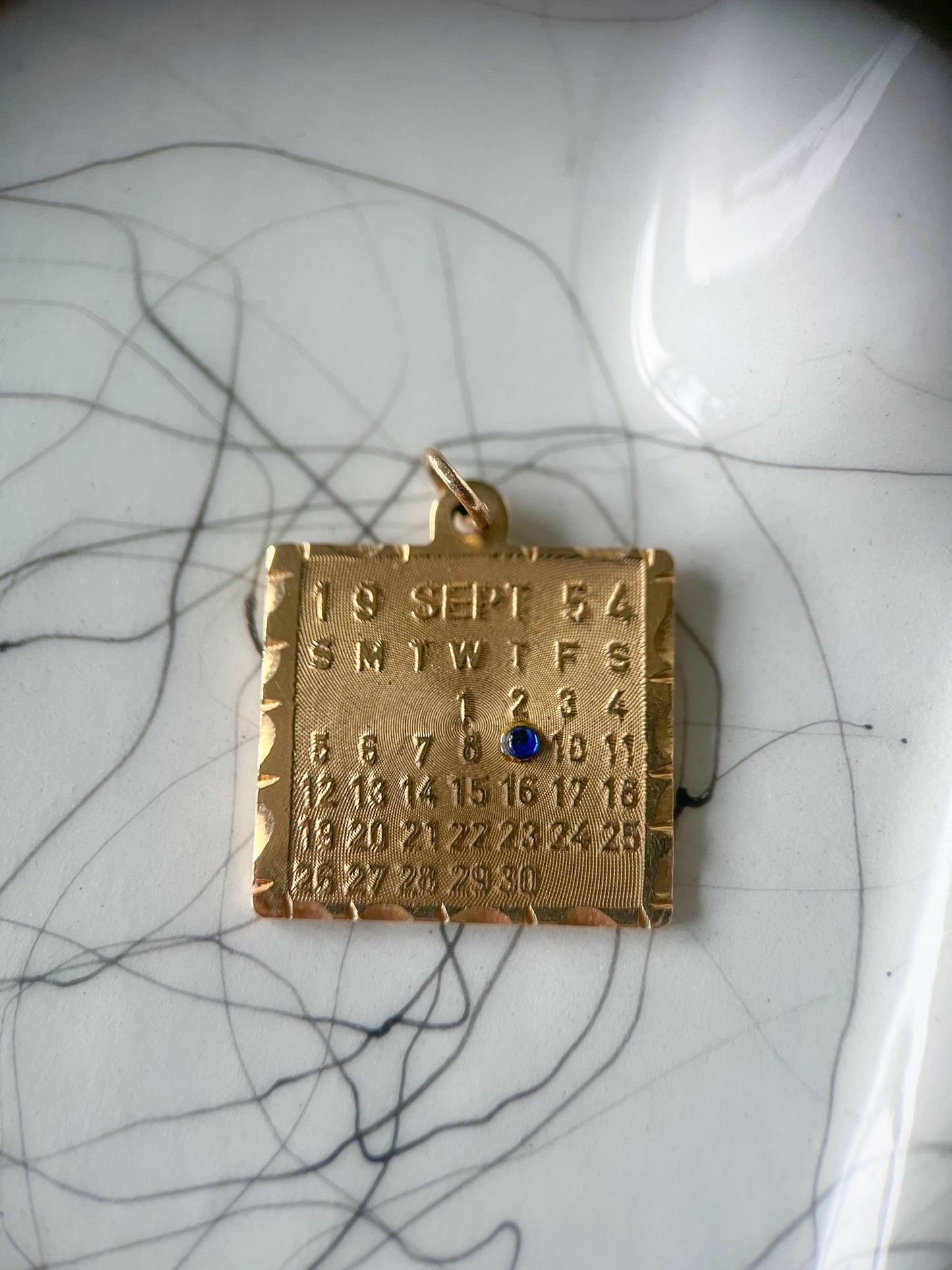 Vintage Calendar with Natural Sapphire 14k Yellow Gold Charm, circa 1950s